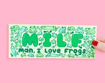 May include: A green and yellow sticker with the word "MILF" spelled out in large green letters. The letters are surrounded by a pattern of green frogs. The text "Man, I Love Frogs" is written below the word "MILF".