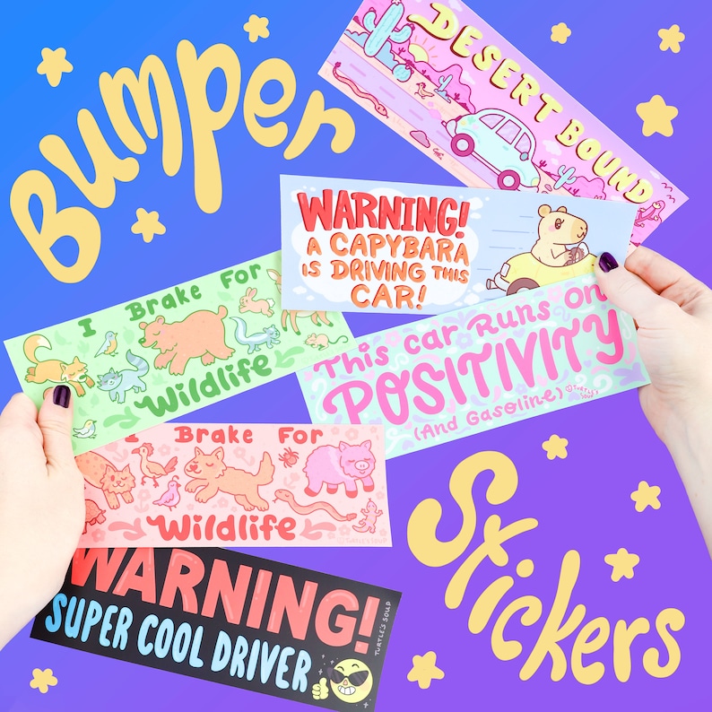 May include: A set of colorful bumper stickers with various designs. The stickers feature illustrations of animals, text, and a cartoon character. The text on the stickers includes "I Brake For Wildlife", "WARNING! A Capybara Is Driving This Car!", "This Car Runs On Positivity (And Gasoline)", and "WARNING! Super Cool Driver".