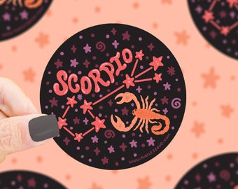 May include: A black circle sticker with a red scorpion and the word "Scorpio" in pink lettering. The sticker is surrounded by pink and white stars on a black background.