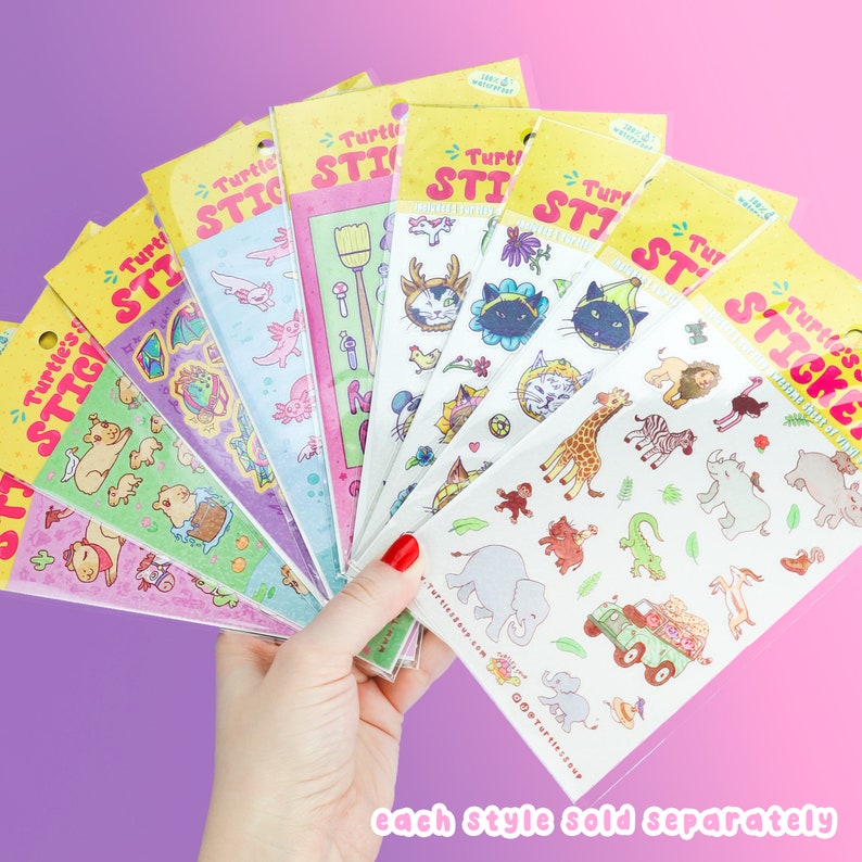 May include: A hand holding several sticker sheets with various colorful designs. The stickers feature cute animals, whimsical objects, and the text "Turtle's Stickers". Each sheet is packaged in a clear plastic sleeve with a yellow header.