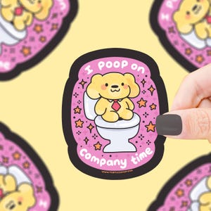 May include: A sticker with a cartoon bear on a toilet, surrounded by stars, with the text "I poop on company time". The bear wears a red tie. The sticker is pink with a black border.