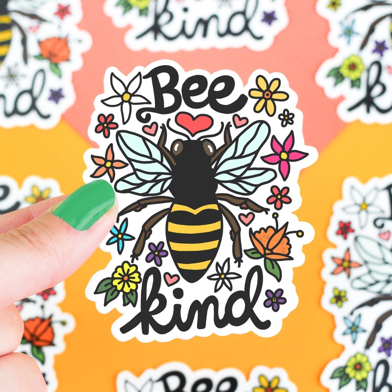 May include: A sticker with a cartoon bee and flowers. The bee is yellow and black with a heart above it. The text "Bee kind" is written in black below the bee.