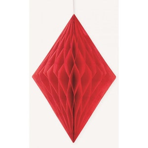May include: A red, diamond-shaped paper decoration, suspended from a white string. The honeycomb structure is visible, creating a textured effect. The decoration is a vibrant red against a plain white background.