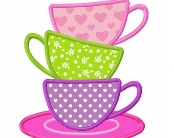 May include: A stack of three teacups with a pink saucer. The top cup is pink with white hearts, the middle cup is green with white flowers, and the bottom cup is purple with white polka dots.