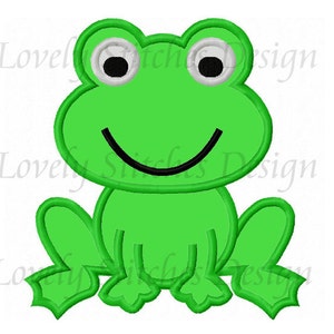 May include: A green frog with a big smile and large black eyes. The frog is sitting with its legs crossed and has a green body with white eyes.
