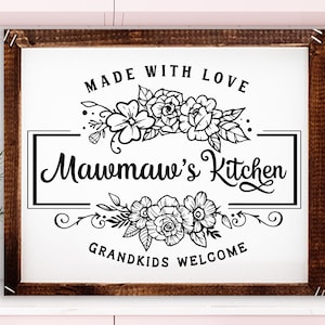 May include: Black and white sign with floral accents that reads "Made with Love Mawmaw's Kitchen Grandkids Welcome".