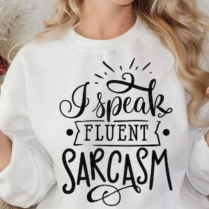 May include: White sweatshirt with black text that reads "I speak fluent sarcasm".