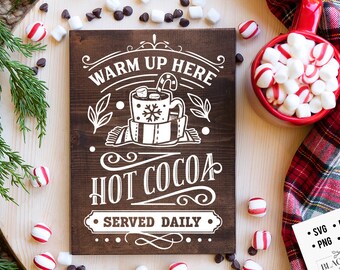 May include: A wooden sign with white text that reads "Warm Up Here Hot Cocoa Served Daily". The sign features a stylized illustration of a mug of hot cocoa with marshmallows and a candy cane.