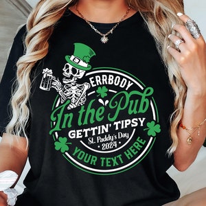 May include: Black t-shirt with a green circle graphic featuring a skeleton holding a beer, shamrocks, and the text "Errbody In the Pub Gettin' Tipsy St. Paddy's Day 2024 Your Text Here".