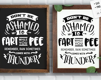 May include: Two framed signs with a black and white design. The signs say "Don't be ashamed to fart while you pee. Remember, rain sometimes comes with thunder."
