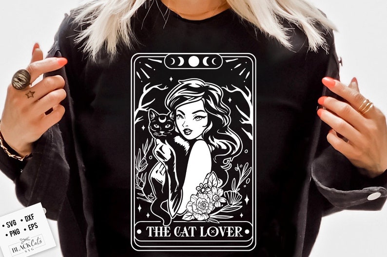 May include: Black long-sleeve shirt featuring a white graphic of a woman holding a black cat, with the text "THE CAT LOVER." The design includes floral and celestial elements. The shirt also has the text "SVG, DXF, PNG, EPS" and the logo "BLACK Cats SVG".