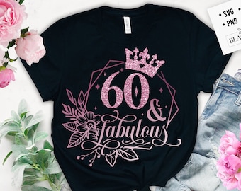 May include: A black t-shirt with a pink glitter design that says "60 & fabulous" with a crown above the number 60. The design is surrounded by a geometric frame and floral accents.