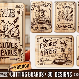 May include: A collection of wooden cutting boards with engraved designs. One board features vegetables and the text "ENQUÊTE EN COURS LÉGUMES DISPARUS." Other boards have humorous illustrations of a cow, vegetables, and a rooster.