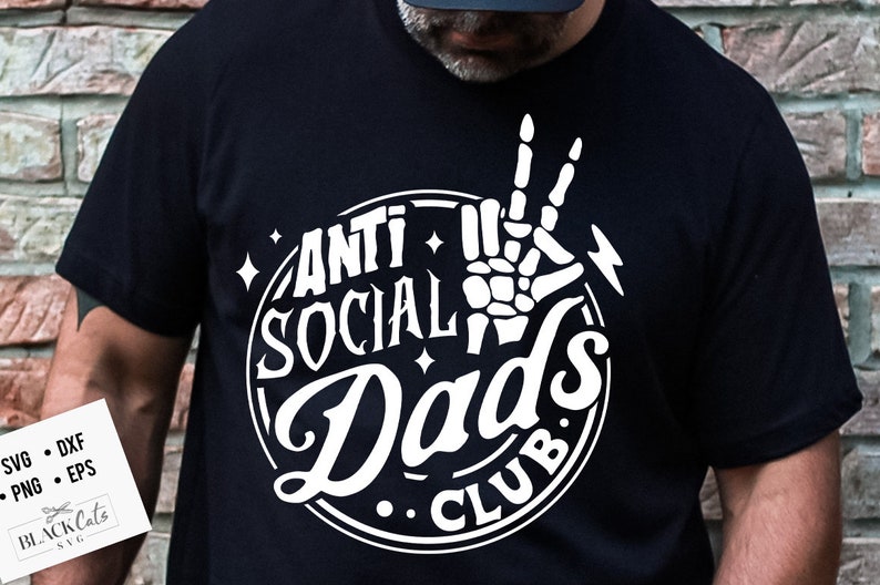 May include: A black t-shirt with a white circle graphic that says "Anti Social Dad's Club". A skeleton hand with a peace sign is in the center of the circle.