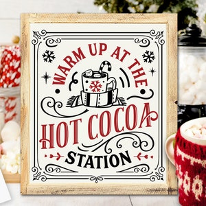 Peut inclure: Une pancarte blanche avec des lettres noires et rouges qui disent "Warm Up At The Hot Cocoa Station". La pancarte présente une illustration stylisée d'une tasse de chocolat chaud avec des guimauves et une canne en sucre.