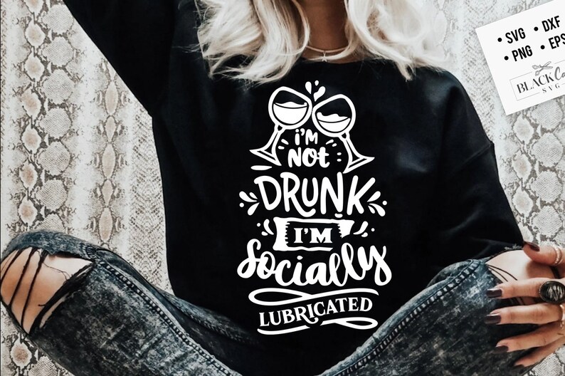 May include: A black sweatshirt with white text that reads "I'm not drunk I'm socially lubricated" with two wine glasses above the text.