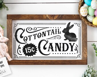 May include: A framed sign with a white background and black text that reads "Cottontail Candy 15c". The sign features a vintage-style font and a silhouette of a rabbit.