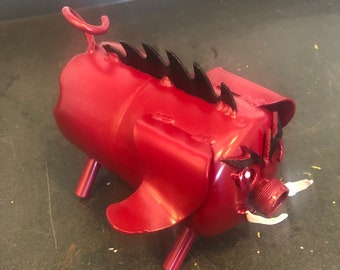 Razorback pig made from recycled metal and farm parts and Colman propane pig yard art