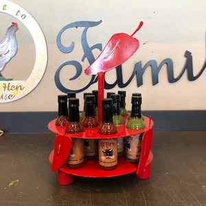 Hot sauce display stand holds 12 bottles of hot sauce with chili peppers made out of steel hot sauce caddy