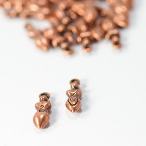 bulk jewelry charms in antique copper featuring strong woman in boho style for necklaces and bracelets