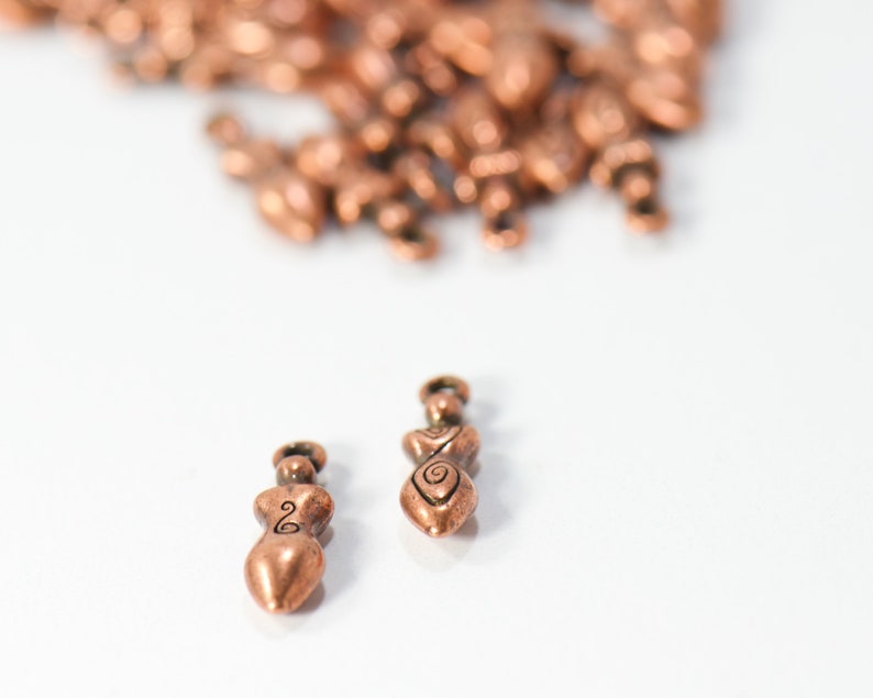 bulk jewelry charms in antique copper featuring strong woman in boho style for necklaces and bracelets