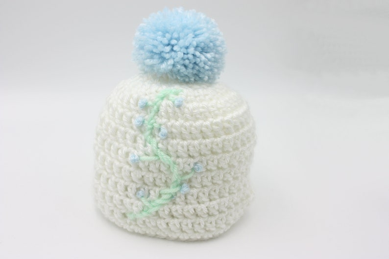 White Baby Hat With Blue Floral Embroidery and Blue Pompom Newborn Hat