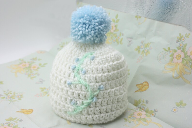 White Baby Hat With Blue Floral Embroidery and Blue Pompom Newborn Hat