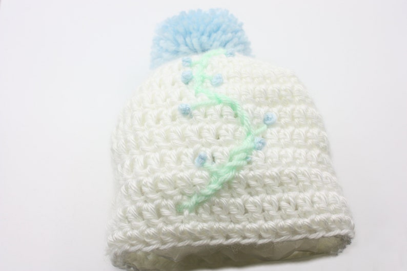 White Baby Hat With Blue Floral Embroidery and Blue Pompom Newborn Hat