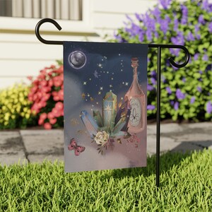May include: A garden flag with a whimsical design featuring a bottle of potion, crystals, a butterfly, and a crescent moon on a starry night background.