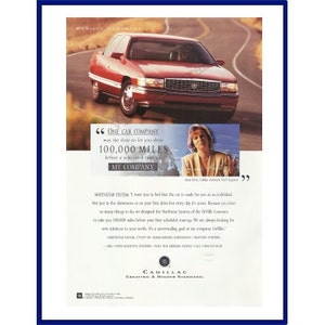 May include: An advertisement for a red Cadillac sedan driving on a winding road. The ad includes text stating "One car company was the first to let you drive 100,000 miles before a scheduled energy". The Cadillac logo is at the bottom.