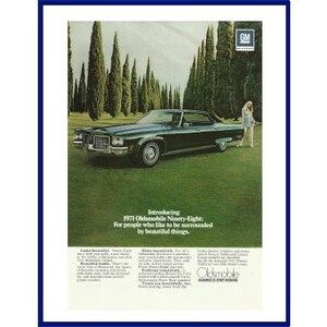 OLDSMOBILE NINETY-EIGHT Automobile Original 1971 Vintage Color Print Advertisement - Black 4-Door Car with Woman in Mod Clothing