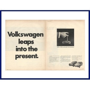 May include: A black and white magazine advertisement for Volkswagen. The text reads "Volkswagen leaps into the present."  The image shows a hand shifting a gear stick with the text "With a fully automatic transmission."