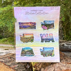 May include: A sticker collection sheet by Barnhouse Studios featuring six nature-themed designs. The stickers depict Hurricane Ridge, Washington state outlines with floral and mountain landscapes, and Lake Crescent. The sheet includes text labels.
