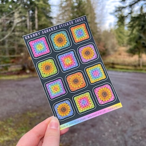 May include: A rectangular sticker sheet titled GRANNY SQUARES STICKER SHEET featuring ten individual stickers of crocheted granny squares in rainbow and sunflower patterns on a black background with website text at the bottom edge.