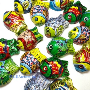 May include: Assortment of colorful foil-wrapped chocolate fish. Each fish is individually wrapped in a different design featuring bright colors and patterns.