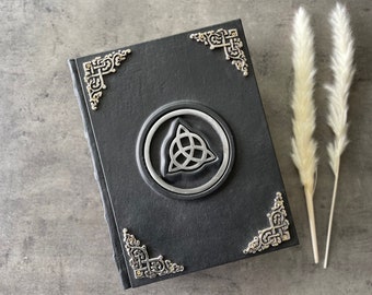 600 page Journal Blank Black Spellbook with Triquetra. 600 pages front and back. Clasps on the side.