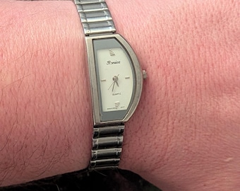 Vintage Ladies Ronica Half Moon Quartz watch with new battery. Best fits up to 8” wrist