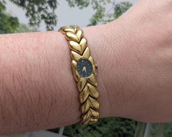 Vintage SEIKO Gold Tone Quartz Watch with Small Black Dial and New Battery.  Best fits 6” wrist or smaller.