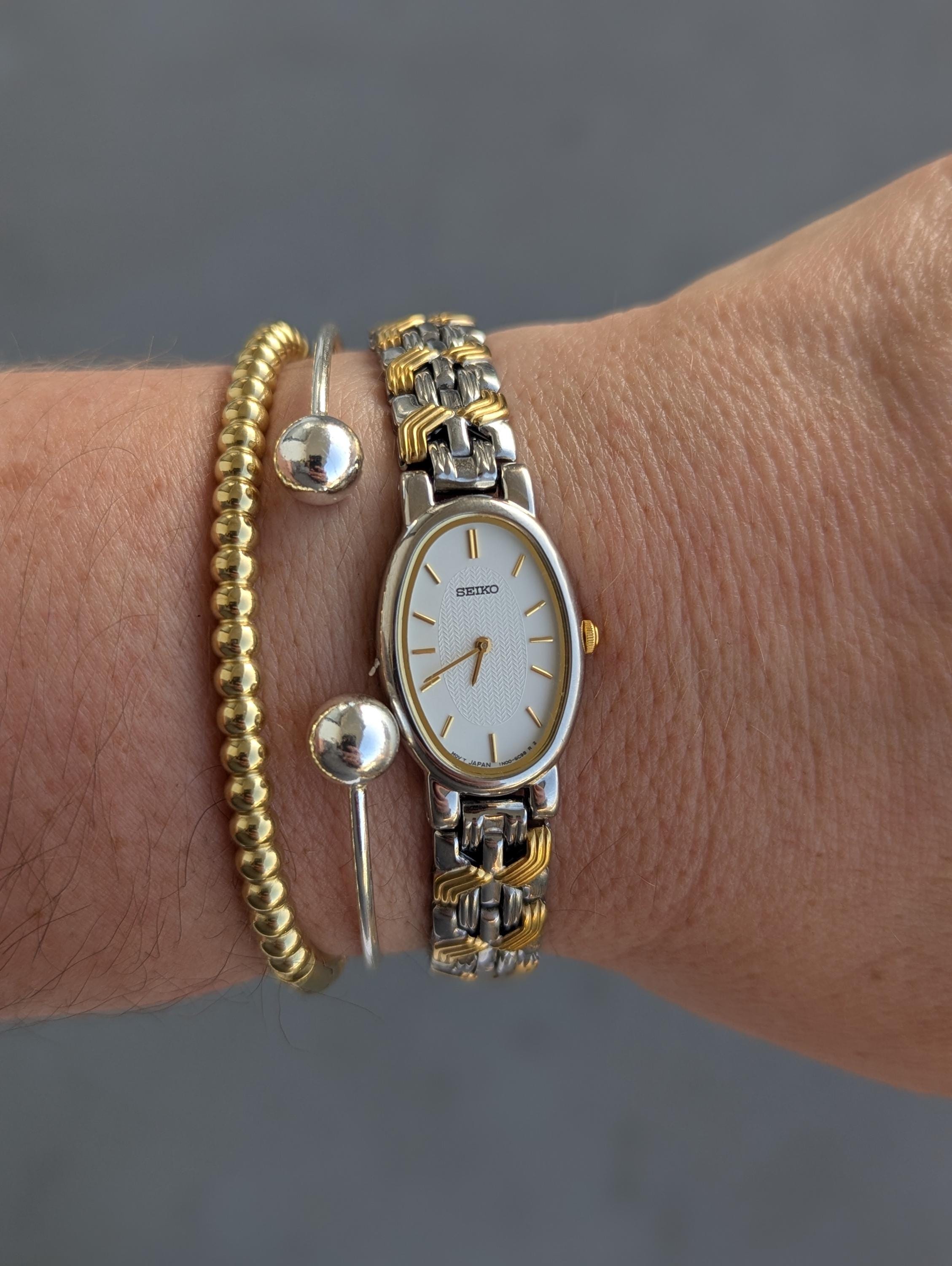 Vintage SEIKO Teo Tone Quartz Watch with Oval Bezel and New Battery. This Best fits 7.5” wrist or smaller.