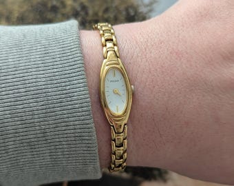 Vintage PULSAR Gold Tone Quartz Watch with Oval Bezel and New Battery. This Best fits 7” wrist or smaller.