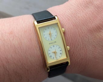 Vintage AVALON Gold Tone Dual Face Quartz Watch with Yellow Face, New Black Leather Band and New Battery. Best fits up to 7.5” wrist.