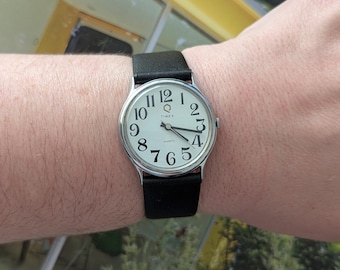 Vintage TIMEX Silver Tone Quartz Watch with New Black Leather Band and New Battery. Best fits up to 8” wrist or smaller.