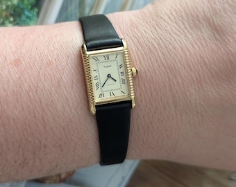 Vintage PULSAR Gold Tone Tank Quartz Watch with Ribbed Bezel, New Black Leather Band and New Battery.  Best fits 7.5” wrist or smaller.