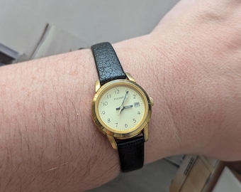 Vintage PULSAR Gold Tone Quartz Watch with Round Bezel, New Black Leather Band and New Battery.  Best fits 7.5” wrist or smaller.