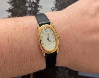 Vintage SEIKO with Large Oval Gold Tone Face, New Bladk Leather Band and New Battery. This Best fits 8” wrist or smaller.