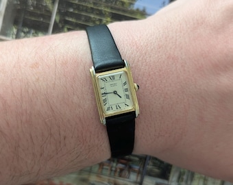 Vintage SEIKO Small Gold Tone Tank Quartz Watch with New Black Leather Band and New Battery.  Best fits 7.5” wrist or smaller.
