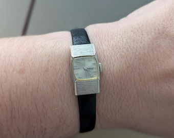 Vintage SEIKO Silver Tone Winding Watch with New Black Leather Band. Best fits 6.5” wrist or smaller.