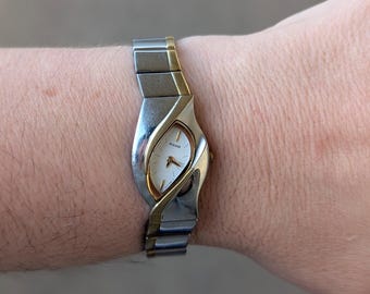 Vintage PULSAR Two Tone Quartz Watch with asymmetrical Case, white Dial and New Battery. Best fits 7.5” wrist or smaller.