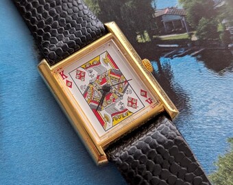 Orologio al quarzo vintage color oro a tema "Re dei Diamanti" con cinturino in pelle nera originale e batteria nuova. Adatto a polsi da 18 cm o più piccoli.