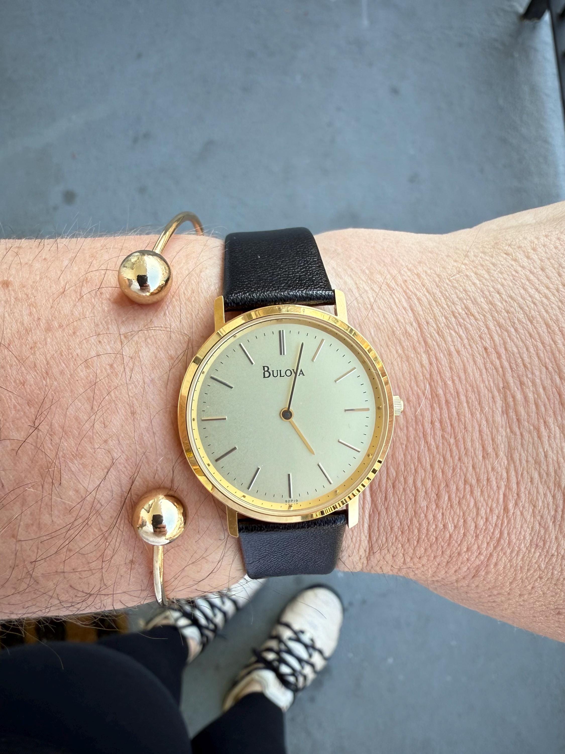 Bulova Gold Tone Dress Watch Champagne Dial Black Leather Strap Quartz Vintage Bulova 12-Hour Dial Gold Plated Case Wristwatches for sale  main image 2